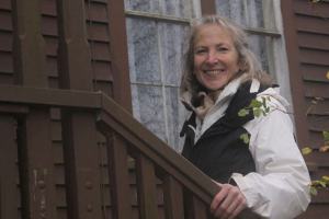Lynn Hyde stands in front of the Haller House on Front Street in Coupeville. She is part of Historic Whidbey