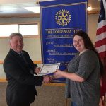 Student of the Month Patricia Hill accepts her certificate from Rotary President Greg Smith.