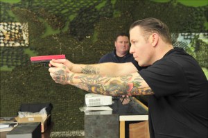 Photo by Michael Watkins/Whidbey News-Times                                George Williams, an apprentice at Snowowl Arms and Training facility, practices markmanship using the indoor laser range in Oak Harbor on Monday.