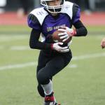 Landon Cantrell looks for running room. (Photo by John Fisken)