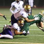 Oak Harbor&rsquo;s Jordan Washington (5) and Brycin McIntryre (8) bring down Timberline&rsquo;s Anthony Hathaway. Hathaway, Timberline&rsquo;s top running threat, gained only 46 yards on 20 carries against the stout Oak Harbor rush defense. (Photo by John Fisken)