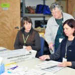 From left to right, Casie Horr, Maggie Paczaowski and and Toni Craggs process ballots in Coupeville Monday.
