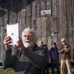 Harrison Goodall, front, takes a group photo in front of the Pratt Sheep Barn, which has been added to Washington&rsquo;sHeritage Barn Register. The barn, located near the bluff on Ebey&rsquo;s Prairie, was restored by Goodall and a group ofvolunteers three years ago.