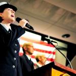 US Navy Petty Officer Third Class Arielle Morgan, of Fleet Logistics Support Squadron 61, VR-61, sings the National Anthem to kick off the Oak Harbor Area Council Navy League Veteran&rsquo;s Day Program at Oak Harbor High School in Oak Harbor, Wash., Nov. 11, 2016. Photo by Michael Watkins/Whidbey News-Times