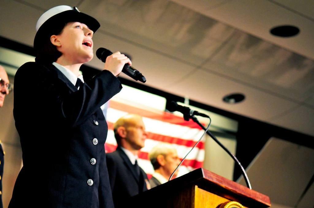 US Navy Petty Officer Third Class Arielle Morgan, of Fleet Logistics Support Squadron 61, VR-61, sings the National Anthem to kick off the Oak Harbor Area Council Navy League Veteran&rsquo;s Day Program at Oak Harbor High School in Oak Harbor, Wash., Nov. 11, 2016. Photo by Michael Watkins/Whidbey News-Times