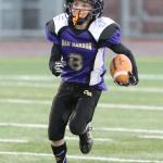 Tristan Gallaway breaks away for a big gain Saturday for the Oak Harbor Midget team. (Photo by John Fisken)