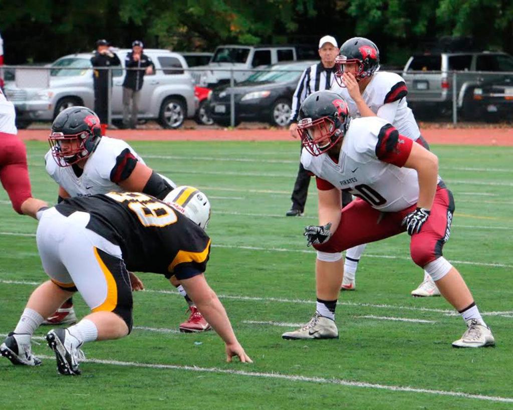 Tyler Adamson, front right, prepares to prodect quarterback Ian Kolste. (Photo courtesy of Whitworth Athletics)