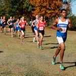 Dejon Devroe, right, runs to 17th place in his conference championship meet. (Photo by Charles Edgeworth)