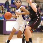 Oak Harbor&rsquo;s Rashanna Graham tries to drive by Lakewood&rsquo;s Jenna Langdon. (Photo by John Fisken)