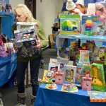 Volunteer Christian Wertz organizes toy displays Thursday in preparation for the opening of Holiday House, a program that provides Christmas gifts to families in need in Oak Harbor and Coupeville. Photo by Megan Hansen/Whidbey News-Times