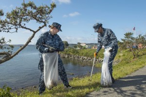Photo by Mass Communication Specialist 3rd Class Caleb Cooper                                Petty Officer 3rd Class Victoria Henson, left, and Seaman Samantha Albert pick up trash during Naval Air Station Whidbey Island&rsquo;s Maylor Point Trail cleanup April 22 in Oak Harbor.