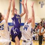 Wildcat Gabe Salinger splits Falcon defenders Anton Klein (22) and Tyler Dow (24) for two points. (Photo by John Fisken)