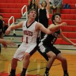 Coupeville&rsquo;s Gabe Wynn (1) battles for rebounding position on a free throw with Klahowya&rsquo;s Garett Betzing. (Photo by Jim Waller)