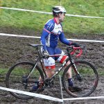 John Clark finds it easier to carry his bike than to ride in this muddy section of the course. (Photo by John Fisken)