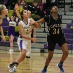 Oak Harbor&rsquo;s Mikhaela Cortez tries to work around Cascade&rsquo;s Kharial Clark (34) for rebounding position. (Photo by Jim Waller)