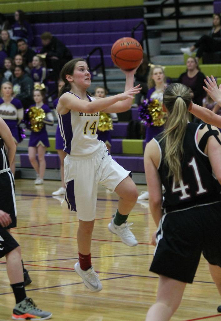 Bryn Langrock shoots a left-handed runner for Oak Harbor. The senior finished with 19 points to pace the Wildcat offense. (Photo by Jim Waller)