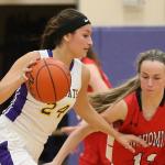 Oak Harbor&rsquo;s Jordan Wood-Pina dribbles by Snohomish&rsquo;s Maya DuChesne. (Photo by John Fisken)