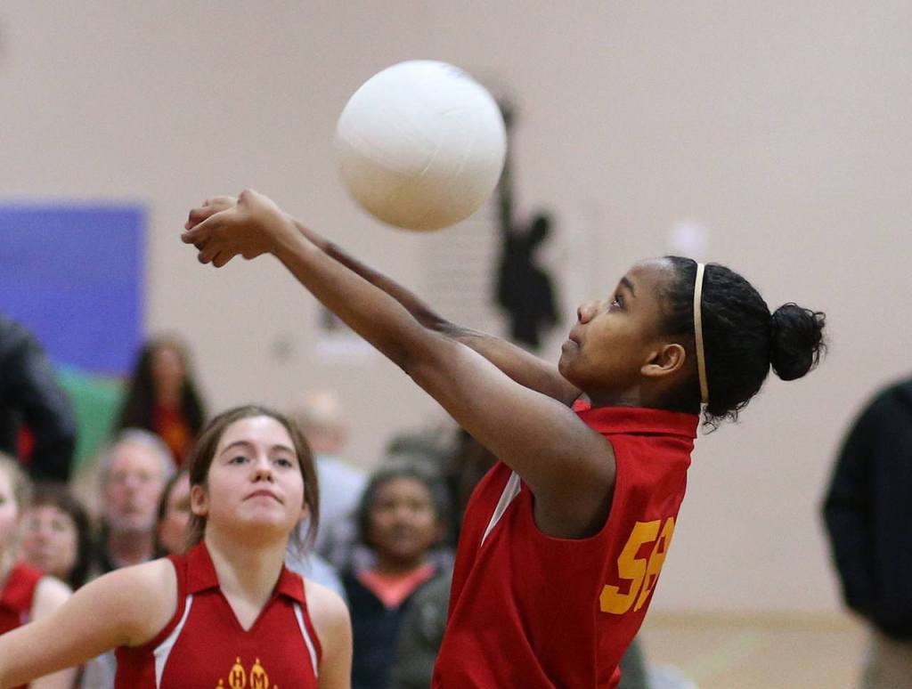 Oak Harbor Middle School eighth-grader Kaziah Rennes passes as Raigen Hansen looks on. (Photo by John Fisken)