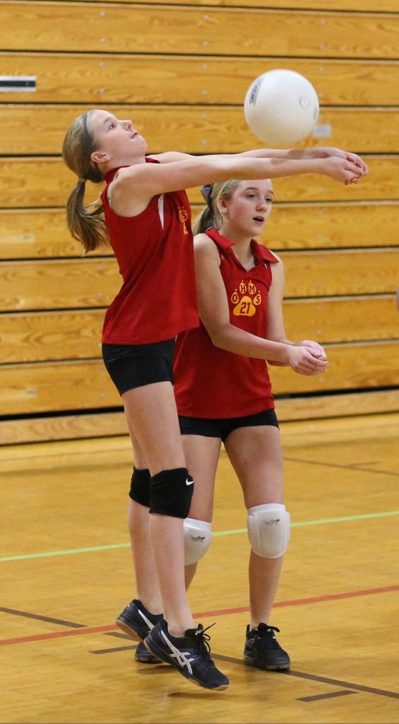 Seventh-grader Lacey Zylstra of Oak Harbor Middle School reaches for a pass in Wednesday&rsquo;s match. (Photo by John Fisken)
