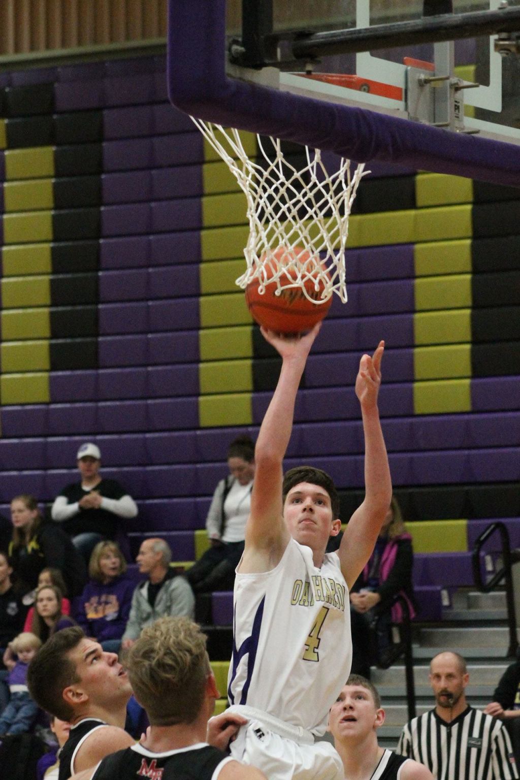 Gabe Salinger appears to by putting the ball up through the net, but he is actually shooting a jumper, which he made, from the far side. (Photo by Jim Waller)