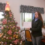 Photo by Dan Warn / Whidbey News-Times                                Near the Christmas tree in a community room at Senior Service&rsquo;s CamBey apartments, Kaci Cheyne, manager of the complex, refers to the establishment&rsquo;s waiting list, a document with 21 names, a physical representation of their inability to find affordable senior housing in Coupeville.