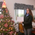 Photo by Dan Warn / Whidbey News-Times                                Near the Christmas tree in a community room at Senior Service&rsquo;s CamBey apartments, Kaci Cheyne, manager of the complex, refers to the establishment&rsquo;s waiting list, a document with 21 names, a physical representation of their inability to find affordable senior housing in Coupeville.