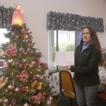 Photo by Dan Warn / Whidbey News-Times                                Near the Christmas tree in a community room at Senior Service&rsquo;s CamBey apartments, Kaci Cheyne, manager of the complex, refers to the establishment&rsquo;s waiting list, a document with 21 names, a physical representation of their inability to find affordable senior housing in Coupeville.