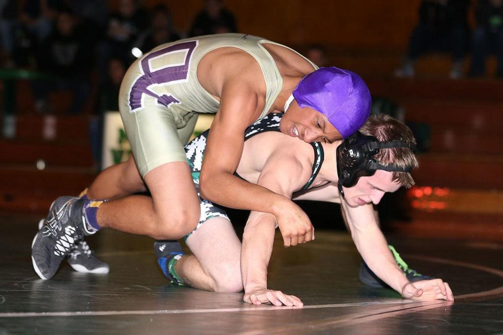 Zion Gomez, top, battles a Mount Vernon wrestler in Thursday&rsquo;s match. (Photo by John Fisken)
