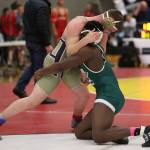 Oak Harbor&rsquo;s Nick Dugin, left, tangles with Edmonds-Woodway&rsquo;s Abdoulie Jatta in the semifinals Saturday. (Photo by John Fisken)