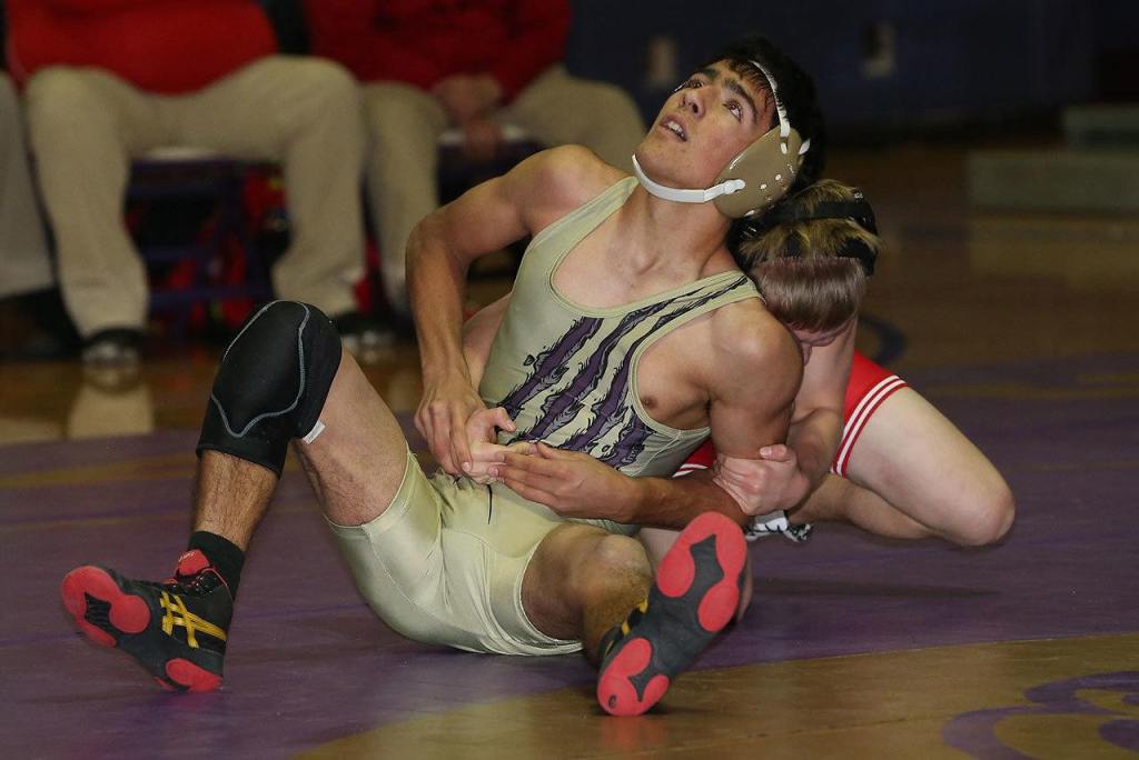 Oak Harbor&rsquo;s Caleb Fitzgerald, front, tries to escape the hold of his M-P opponent. (Photo by John Fisken)
