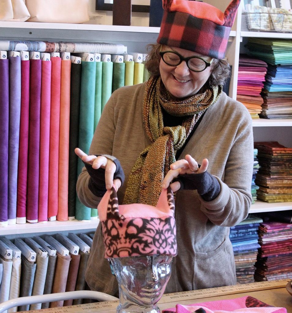 Peggy Juve created her own protest hats from pieces of fleece and stitched them together. An artist and co-owner of Side Market in Bayview Corner, she also sponsored a &ldquo;sit-in&rdquo; for people wanting to gather and create hats. Four busloads from Whidbey are headed to Seattle Jan. 21 for the Women&rsquo;s March on Seattle.                                Photo by Patricia Guthrie/Whidbey News-Times