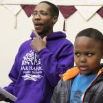 Darreyl Boyles, 9, sings with his father, Charles Boyles III (in front of drums) and Tyrone Vester at practice for the United Fellowship Community Church choir. They will perform 3 p..m Sunday at the House of Prayer in Oak Harbor at an annual event honoring Martin Luther King, Jr.                                Photo by Patricia Guthrie/Whidbey News-Times