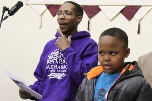 Darreyl Boyles, 9, sings with his father, Charles Boyles III (in front of drums) and Tyrone Vester at practice for the United Fellowship Community Church choir. They will perform 3 p..m Sunday at the House of Prayer in Oak Harbor at an annual event honoring Martin Luther King, Jr.                                Photo by Patricia Guthrie/Whidbey News-Times