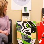 Melissa Riker, executive director of Oak Harbor Main Street Association, is glad to be reunited with the three wooden toy soldiers who went missing in late November. They were found on on a roadside last Saturday. Photo by Ron Newberry/Whidbey News-Times