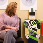 Melissa Riker, executive director of Oak Harbor Main Street Association, is glad to be reunited with the three wooden toy soldiers who went missing in late November. They were found on on a roadside last Saturday. Photo by Ron Newberry/Whidbey News-Times