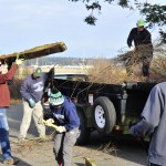 Geoff Moore, left, the Naval Air Station Whidbey Island commanding officer, spends his Martin Luther King Jr. holiday with his family participating in a veteran volunteer project along with the National Parks Conservation Association to help clean up the Prairie Wayside portion of Ebey&rsquo;s Prairie in Coupeville Monday. Photo by Michael Watkins/Whidbey News-Times