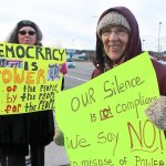 Melissa Duffy, left, from Oak Harbor and Herta Kurp from Anacortes, right, comprised a two-woman protest on the corner of State Route 20 and Whidbey Avenue in Oak Harbor Friday as Donald Trump was sworn in as the 45th president.                                Photo by Patricia Guthrie/Whidbey News-Times