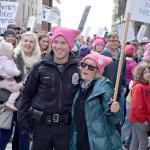 Photo by Patricia Guthrie/Whidbey News-Times                                Seattle Police Officer Benjamin Frieler dons a pink hat and poses with Catherine Lichterman of Langley Saturday at the Womxn&rsquo;s March on Seattle. Hundreds of Whidbey Island residents were among the record-breaking crowd, estimated at 120,000 to 175,000.