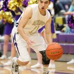 Ty Baker looks to attack the hoop. (Photo by John Fisken)