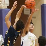 Oak Harbor&rsquo;s Justin Ellison swats away a shot by Everett&rsquo;s Elijah Ross-Rutter. (Photo by John Fisken)