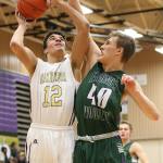 Oak Harbor&rsquo;s Ozell Jackson challenges the defense of E-W&rsquo;s Ryan Peterson. (Photo by John Fisken)