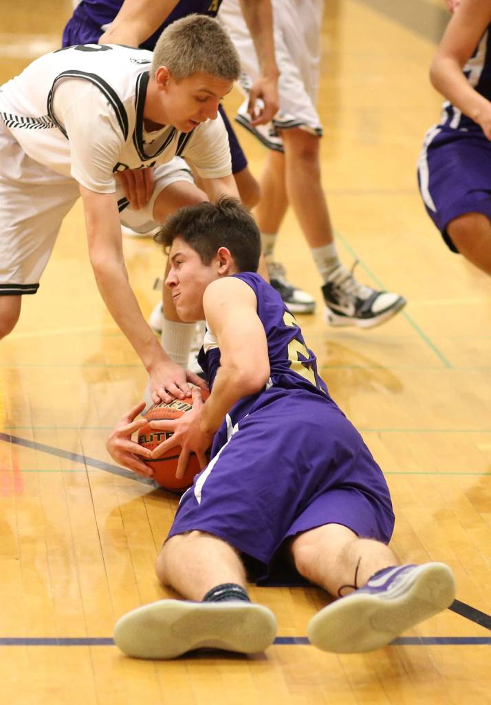 JJ Mitchell scrambles to control a loose ball. Mitchell was praised by coach John Weston for his effort in the game. (Photo by John Fisken)