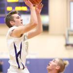 Adam Nelson shoots over the defense of Everett&rsquo;s Bogdan Fesiienko. Nelson led Oak Harbor with 16 points in the game. (Photo by John Fisken)