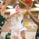 Gabe Salinger goes to the hoop for Oak Harbor. (Photo by John Fisken)