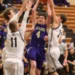 Gabe Salinger attracts a crowd as he heads to the basket. (Photo by John Fisken)