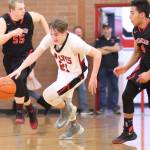 Ethan Spark races up the court by Port Townsend&rsquo;s Kaiden Parcher (55) and Jacob Boucher. (Photo by John Fisken)