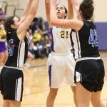 Mikhaela Cortez shoots over the defense of Bella Hotham, left, and Taryn Shelley. (Photo by John Fisken)
