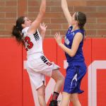 Mikayla Elfrank shoots over the attempted block of Chimacum&rsquo;s Alice Yaley. (Photo by John Fisken)