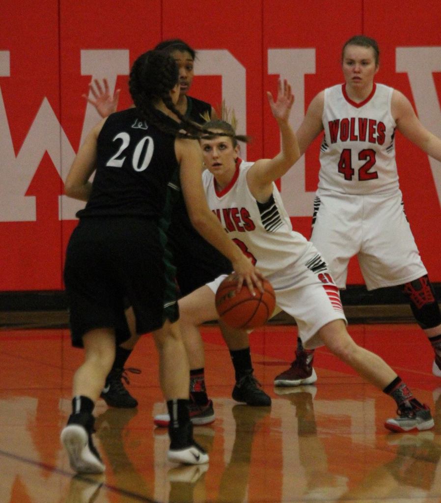 Lauren Grove defends Klahowya&rsquo;s Amber Bumbalough as Kailey Kellner (42) waits to help. (Photo by Jim Waller/Whidbey News-Times)