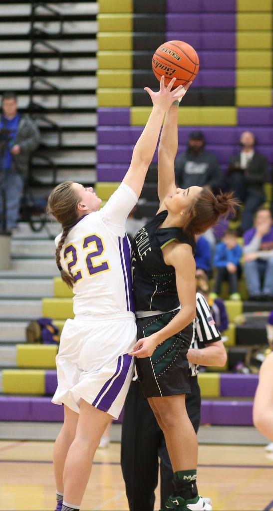 Oak Harbor&rsquo;s Julie Jansen, left, challenge&rsquo;s MG&rsquo;s Oshinaye Taylor on the opening tip. (Photo by John Fisken)